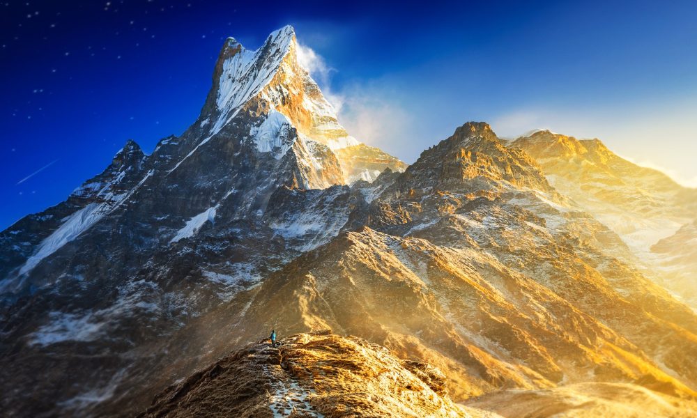 Hiker,Reaches,The,Mountain,Peak,Of,Machapuchare.,A,Mountain,In